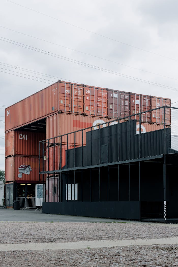 pexels-photo-10620467 Urban scene with stacked shipping containers used for storage and operations.